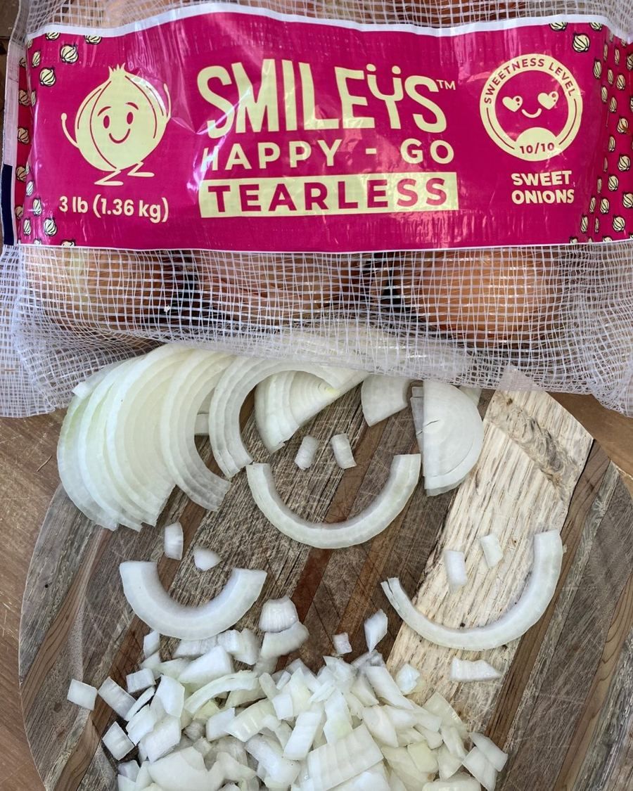 Chopped Smileys arranged into smiley faces on a cutting board below a Smileys bag